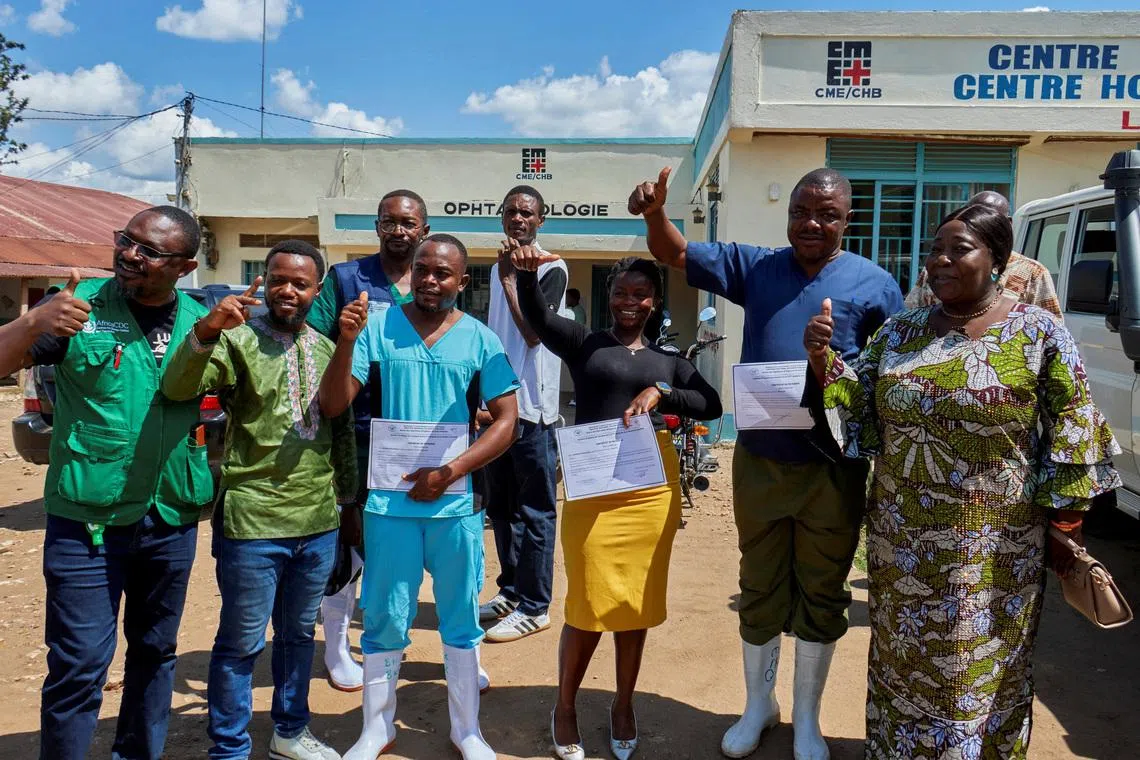 Congolese health workers who recovered from the Ebola virus pose for a photograph at the Evangelical Medical Center in Bunia on May 31.