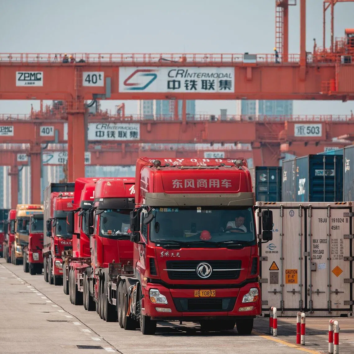 epa12121188 A photo taken during an organized press tour shows trucks loading shipping containers at the Chongqing Railway Container Center Station and New International Land-Sea Trade Corridor Dry Port, in the International Logistics Hub Park in Chongqing, China, 20 May 2025 (issued 21 May 2025).  EPA/ALEX PLAVEVSKI