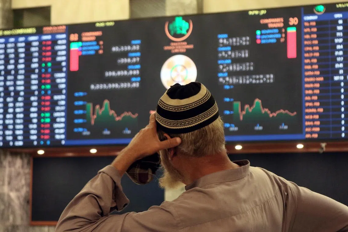 A Pakistani stockbroker monitors share prices during a trading session at the Pakistan Stock Exchange in Karachi on Feb 10, 2023. 