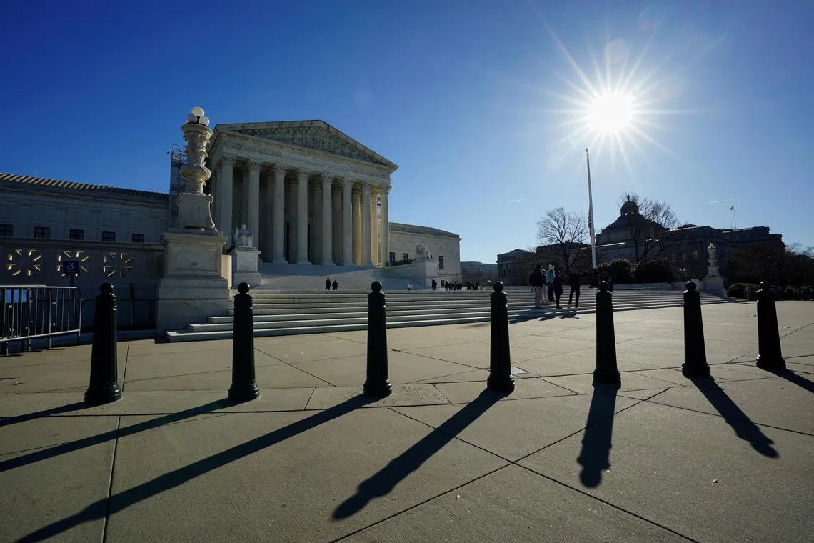 FILE PHOTO: The sun casts shadows as it rises over the U.S. Supreme Court in Washington, U.S., December 20, 2023. REUTERS/Kevin Lamarque/File Photo