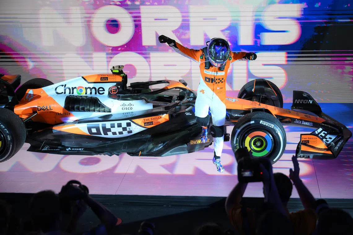 Lando Norris of McLaren F1 Team leaping from his car after winning the Singapore Airlines Singapore Grand Prix on Sept 22, 2024.