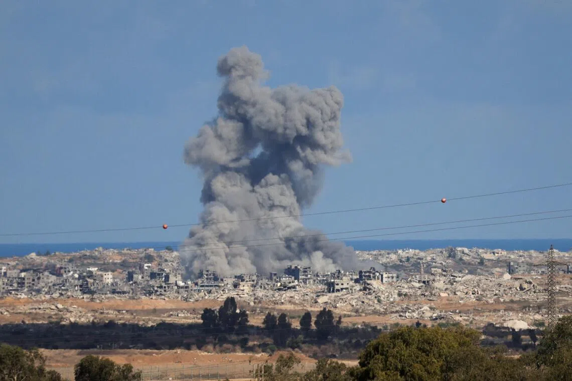 Smoke rises from explosions in Gaza, as seen from southern Israel, on Oct 7.