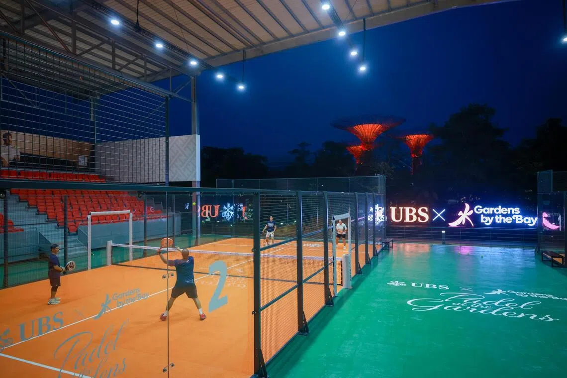 People playing padel at Padel at the Gardens with the Supertrees in the background on Sept 18.