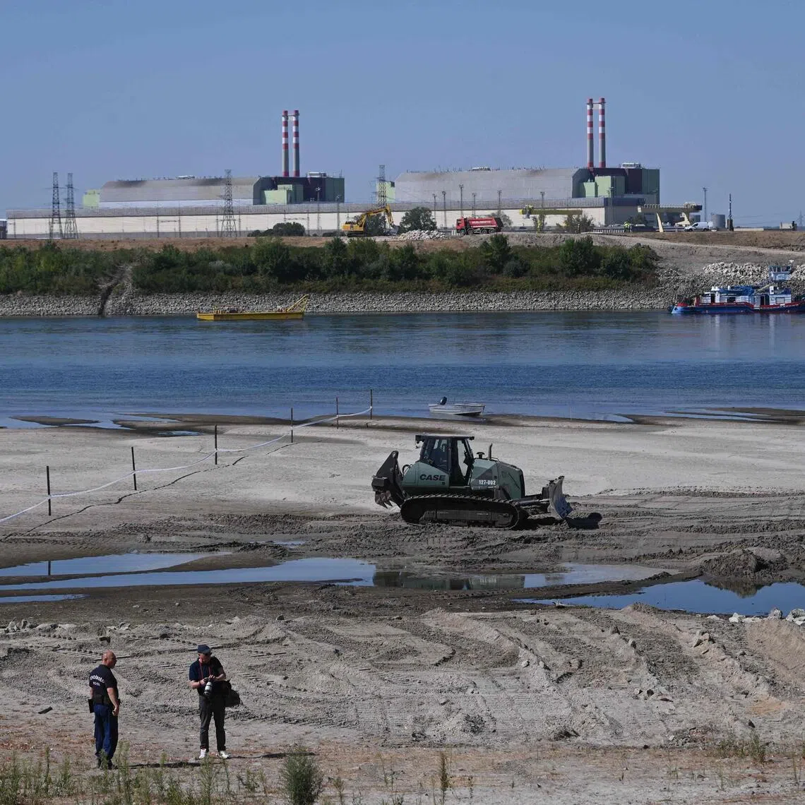 Construction crews working along the banks of the River Danube in Hungary on Aug 14, near the Paks Nuclear Power Plant.