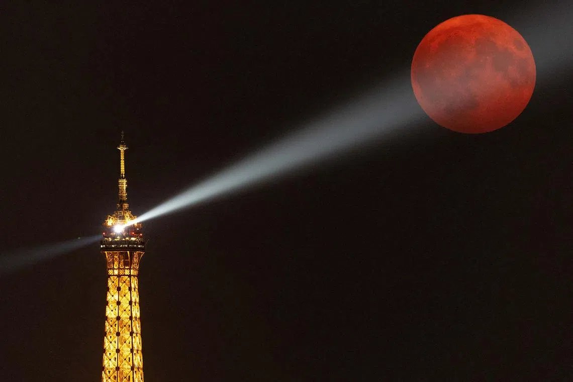 A supermoon, known as the blue moon and "Sturgeon Moon", rising over the Eiffel Tower in Paris, France, Aug 19, 2024. 