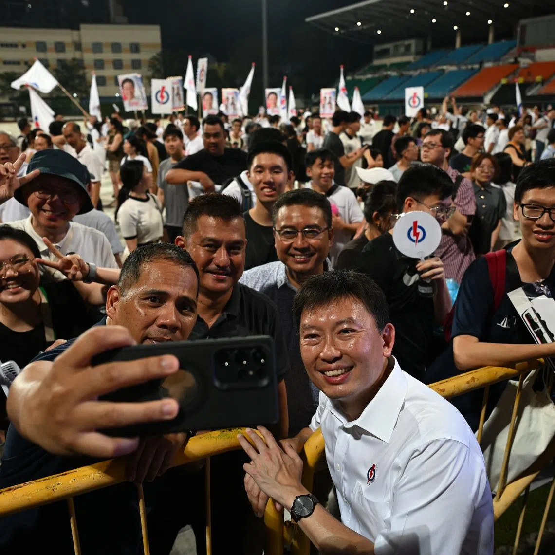 Transport Minister Chee Hong Tat posing for photos with supporters at a PAP rally at Bishan Stadium on April 30.