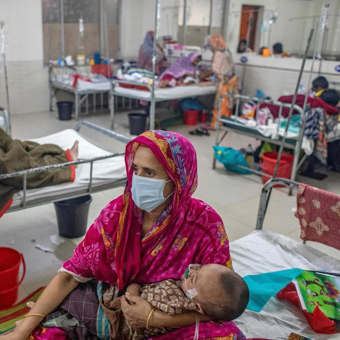 A woman holding a child diagnosed with measles inside a paediatric ward at the Bangladesh Shishu Hospital and Institute in Dhaka on May 6.