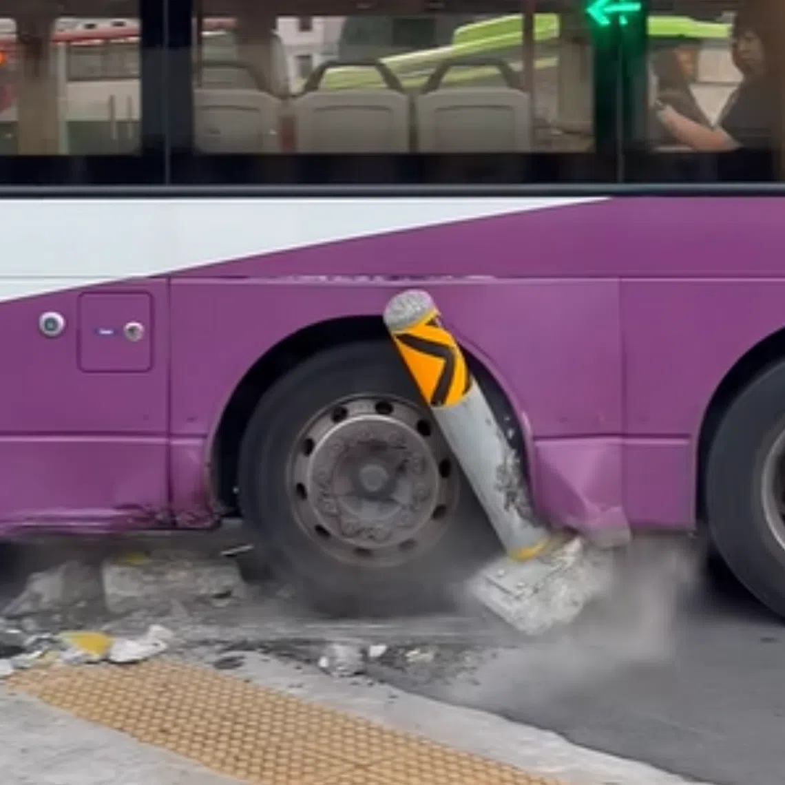 Video footage of the incident shows the left side of a double-decker bus mounted on the corner of a kerb, with a bollard lodged in one of the vehicle’s rear wheels.