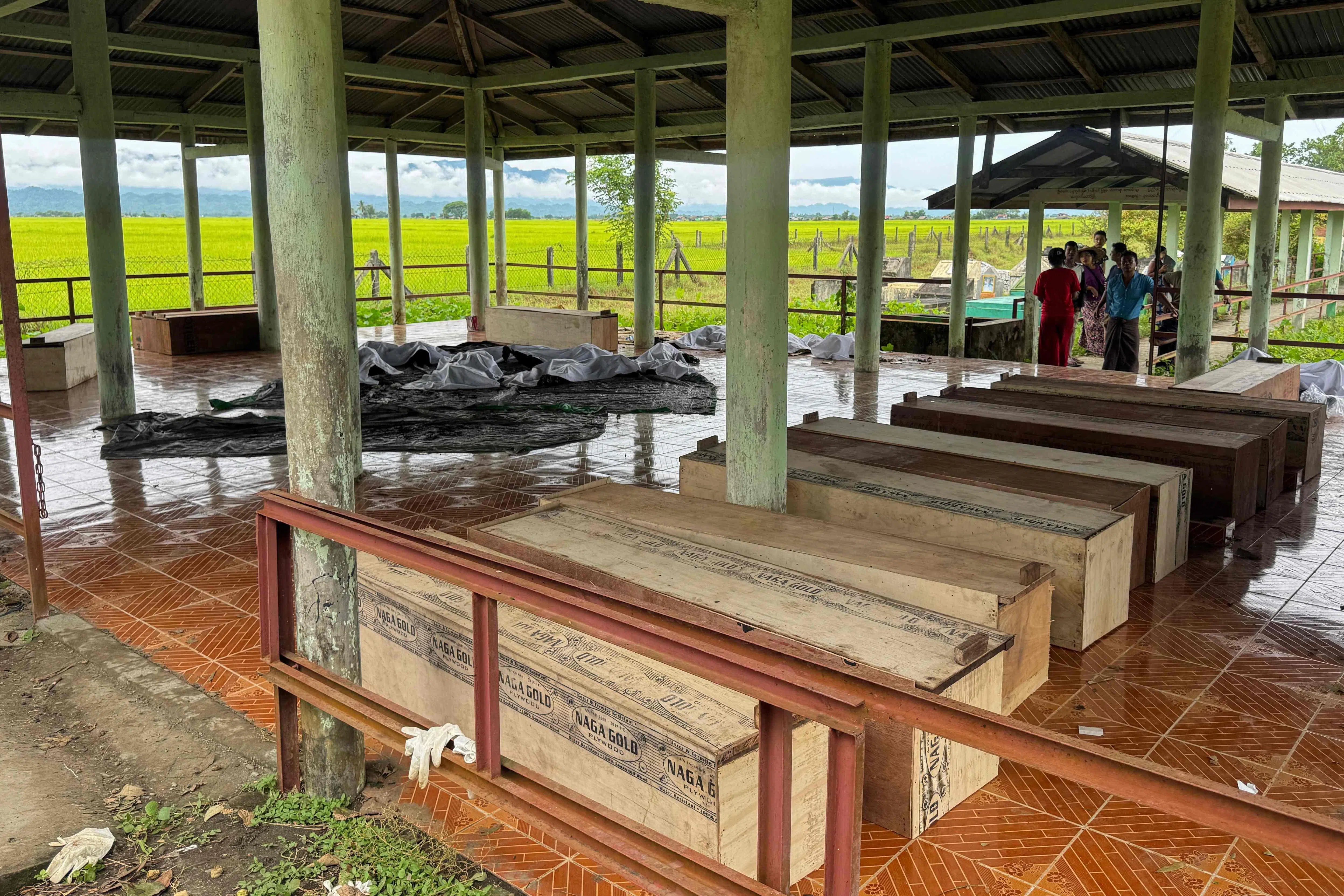 Wooden coffins are lined up inside a shelter on Sept 29, as relatives gather to identify the bodies of their loved ones following the airstrike in Kyauktaw town, Rakhine State, a day earlier.