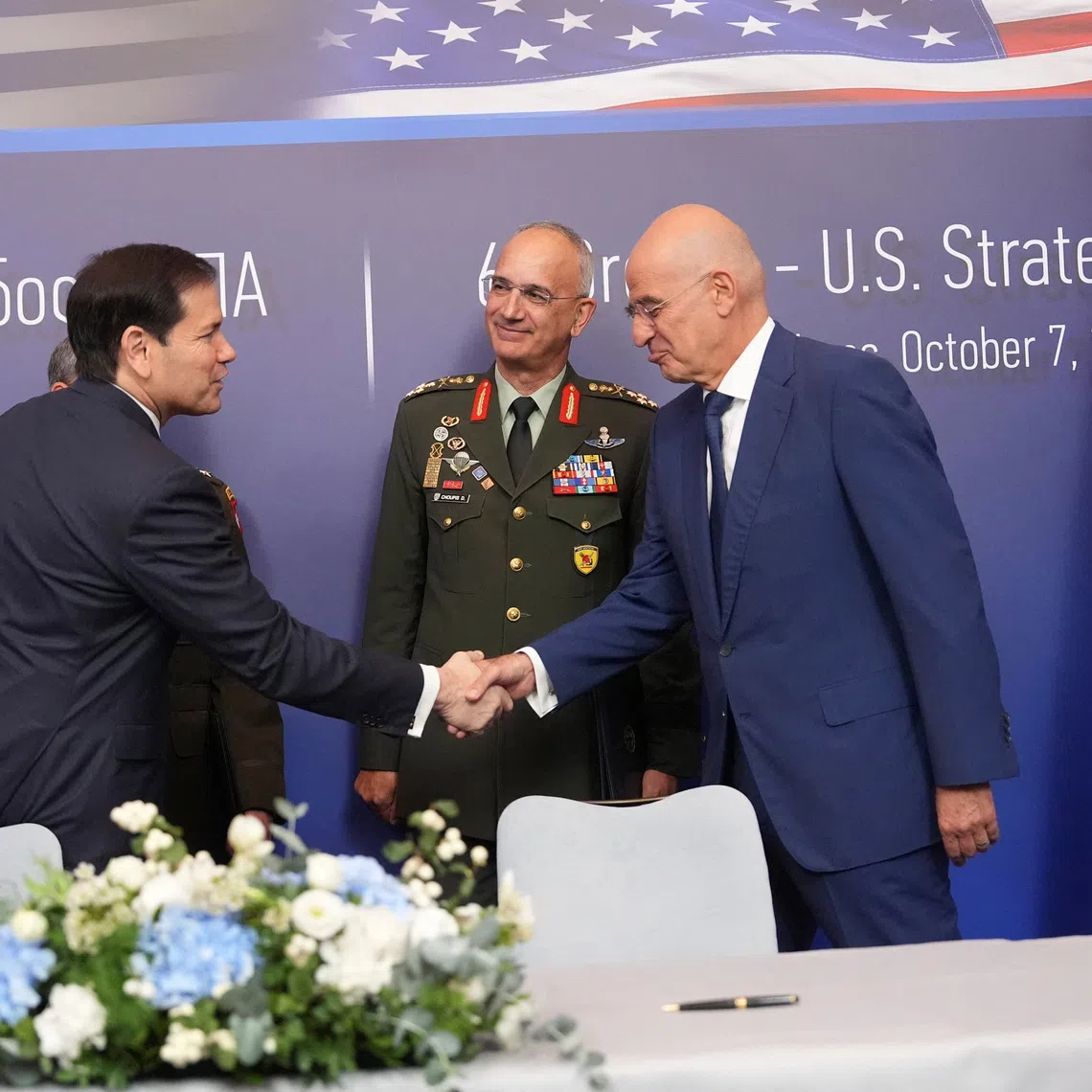 U.S. Secretary of State Marco Rubio,  shakes hands with Greek Defense Minister Nikos Dendias as Gen. Dimitrios Choupis, chief of the Hellenic National Defence General Staff, looks on  during a signing ceremony at the Conrad Hotel in Athens, Greece October 7, 2026.   Mark Schiefelbein/Pool via REUTERS