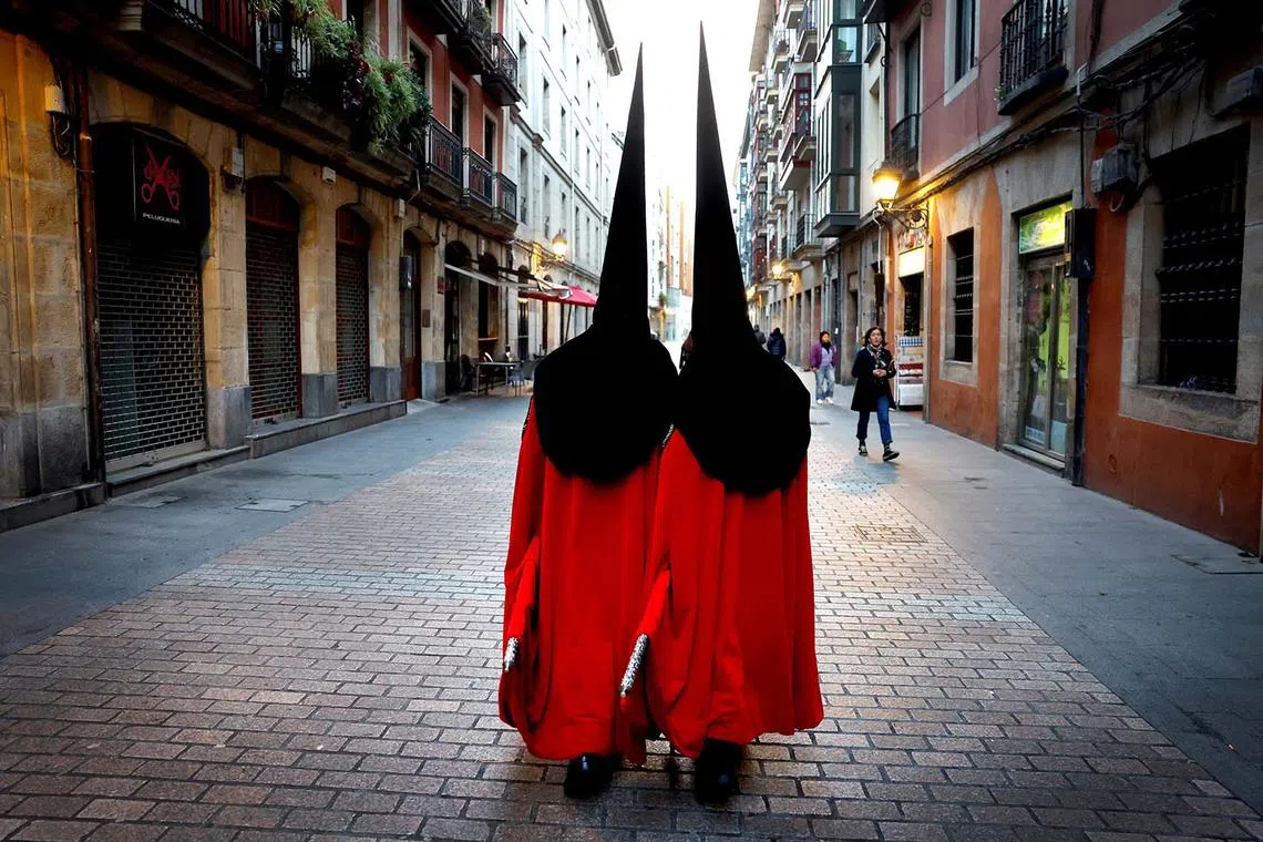Penitents taking part in a procession during Holy Week in Bilbao, Spain, April 16, 2025. 