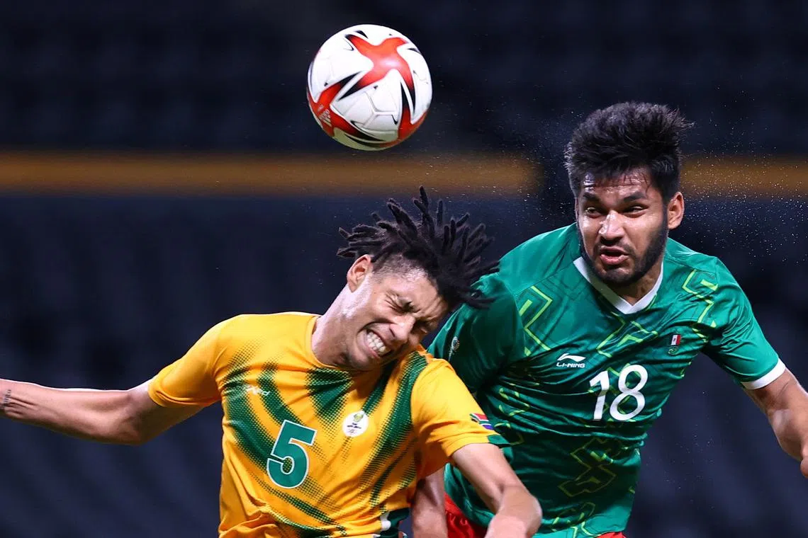 FILE PHOTO: Tokyo 2020 Olympics - Soccer Football - Men - Group A - South Africa v Mexico - Sapporo Dome, Sapporo, Japan - July 28, 2021. Luke Fleurs of South Africa in action with Eduardo Aguirre of Mexico REUTERS/Kim Hong-Ji/File Photo