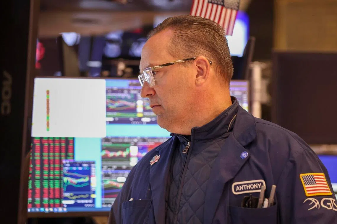 A trader working on the New York Stock Exchange floor after the opening bell on May 8.