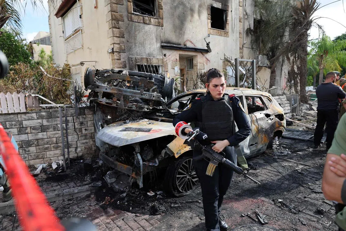 A member of the Israeli security forces stands guard inside a cordoned-off area in Kiryat Bialik in the Haifa district of Israel, on Sept 22, 2024.