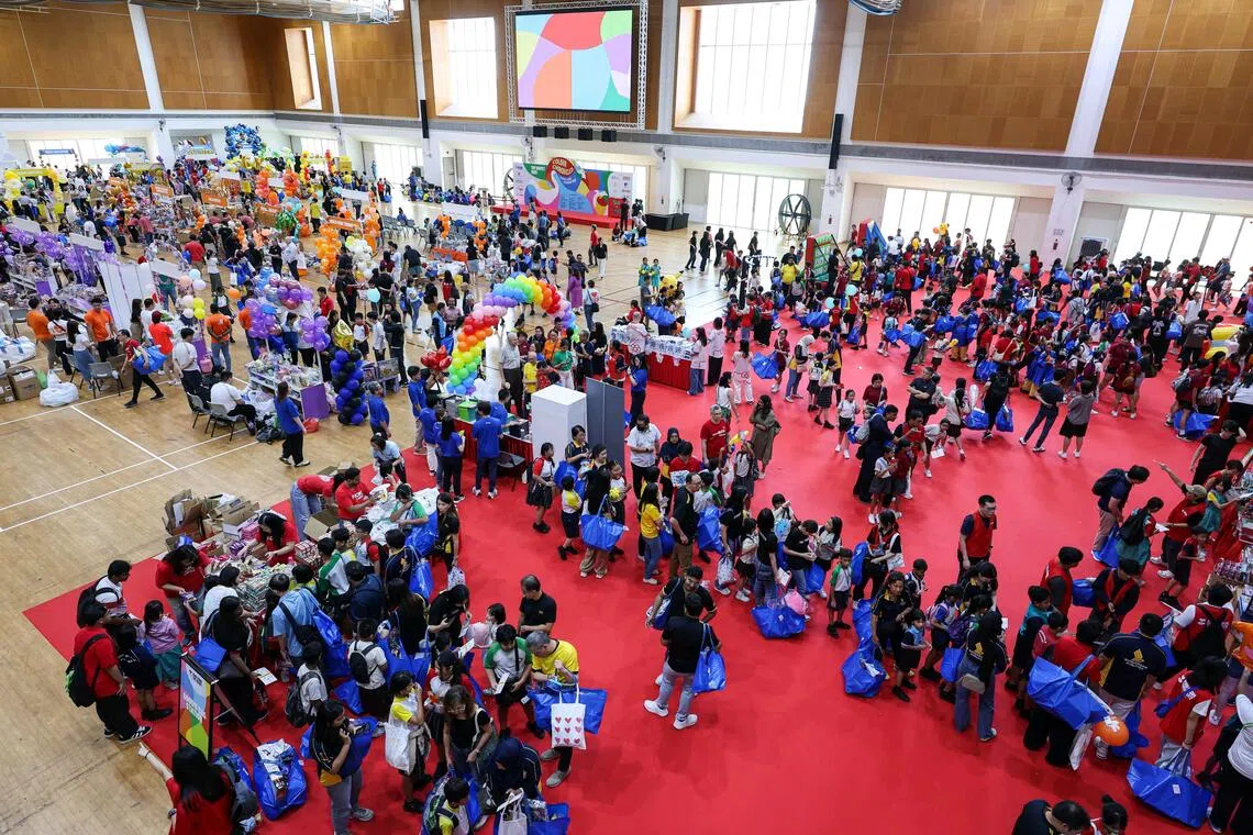 Children choosing toys and playing at game booths at the Toy Buffet at ITE College Central on Nov 14.