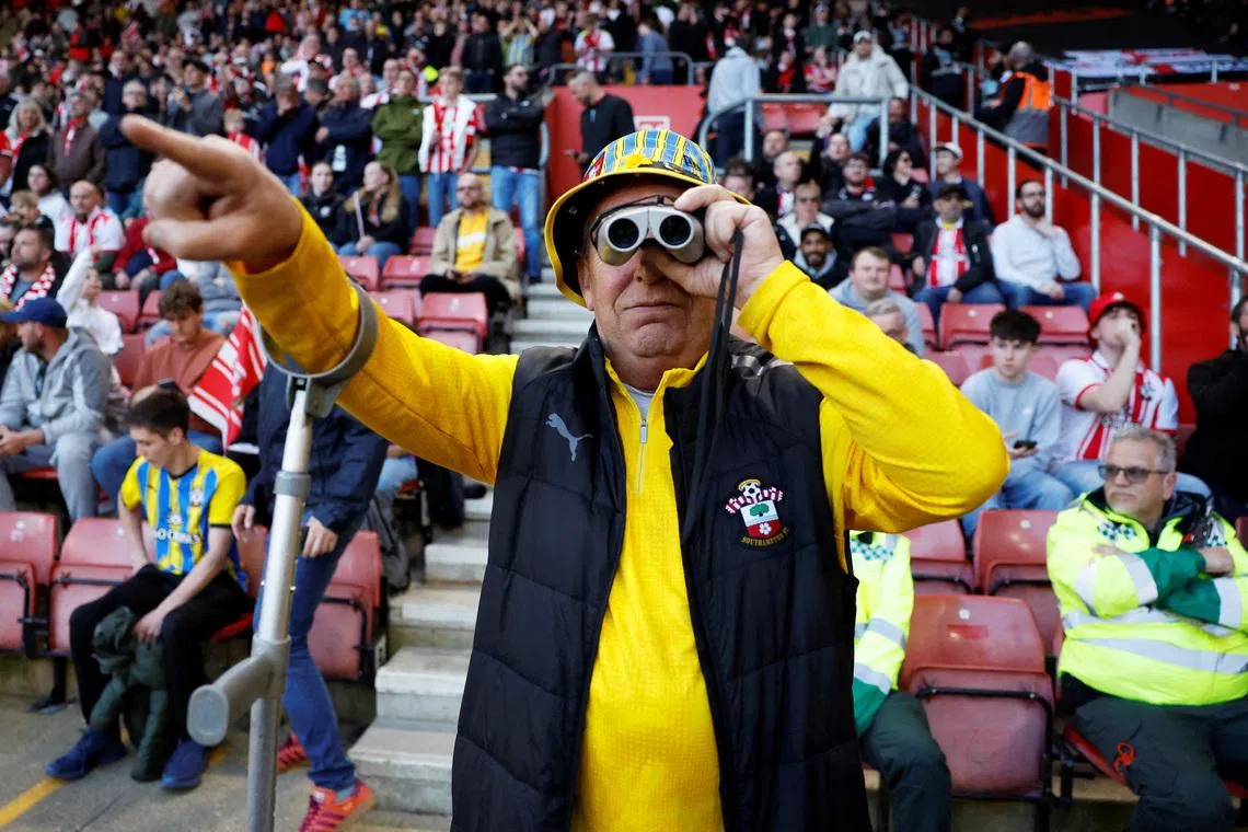 FILE PHOTO: Soccer Football - Championship - Play Offs - Semi Final - Second Leg - Southampton v Middlesbrough - St Mary's Stadium, Southampton, Britain - May 12, 2026 A Southampton fan with binoculars is seen in the stands during the match Action Images/Peter Cziborra/File Photo