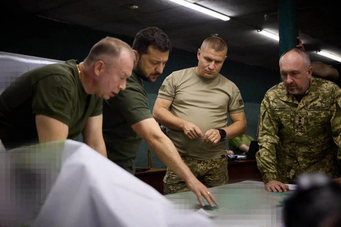 Ukrainian General Oleksandr Syrskyi (left) and President Volodymyr Zelensky (second from left) visit troops engaged in offensive operations in the Bakhmut sector, in Ukraine's Donetsk region.