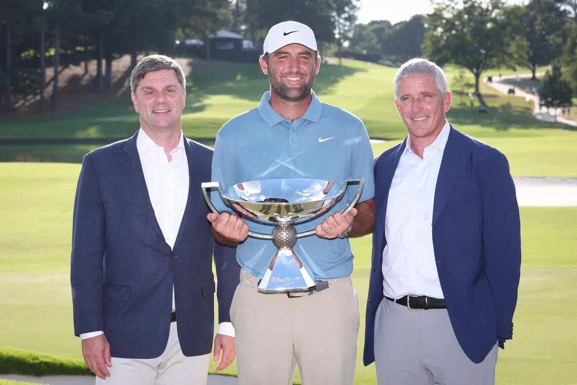 Tour Championship and FedEx Cup winner Scottie Scheffler with PGA Tour CEO Brian Rolapp (left) and commissioner Jay Monahan at East Lake Golf Club in Atlanta, Georgia on Aug 30.
