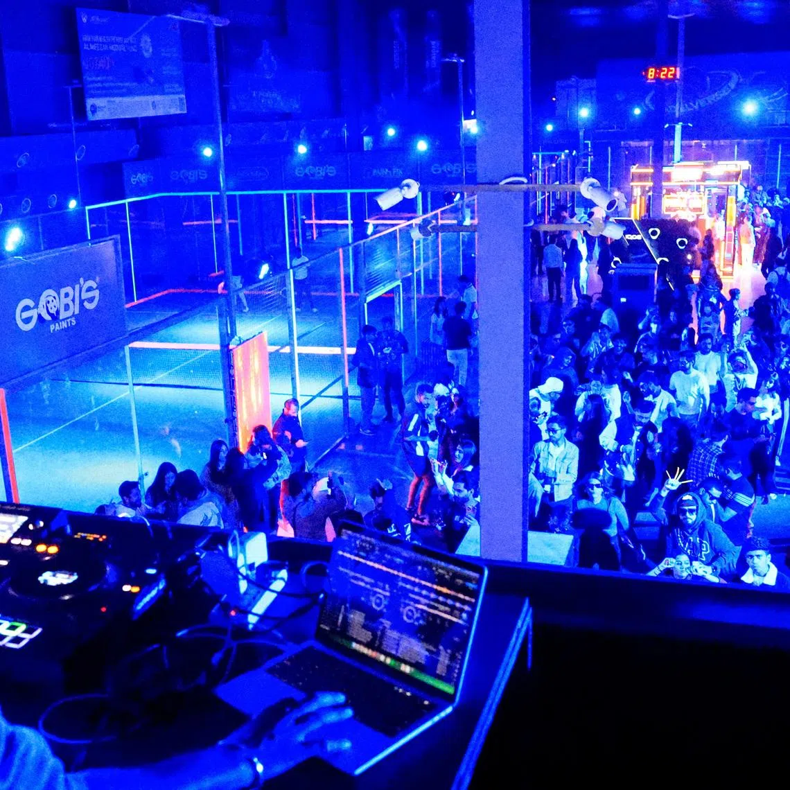 Sagar Naik, known as DJ Sagar, plays at a neon padel party organised by 12xperience, at Padelverse in Karachi, Pakistan, November 29, 2025. REUTERS/Akhtar Soomro