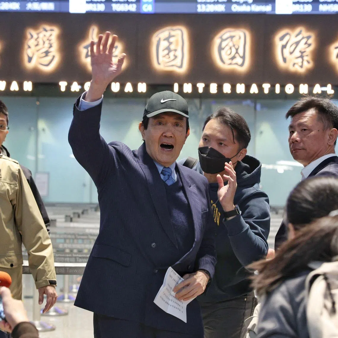 Taiwan's former president Ma Ying-jeou waves to the media at Taoyuan International Airport before leading a delegation of Taiwanese students to China, in Taoyuan on December 18, 2024. (Photo by I-Hwa Cheng / AFP)
