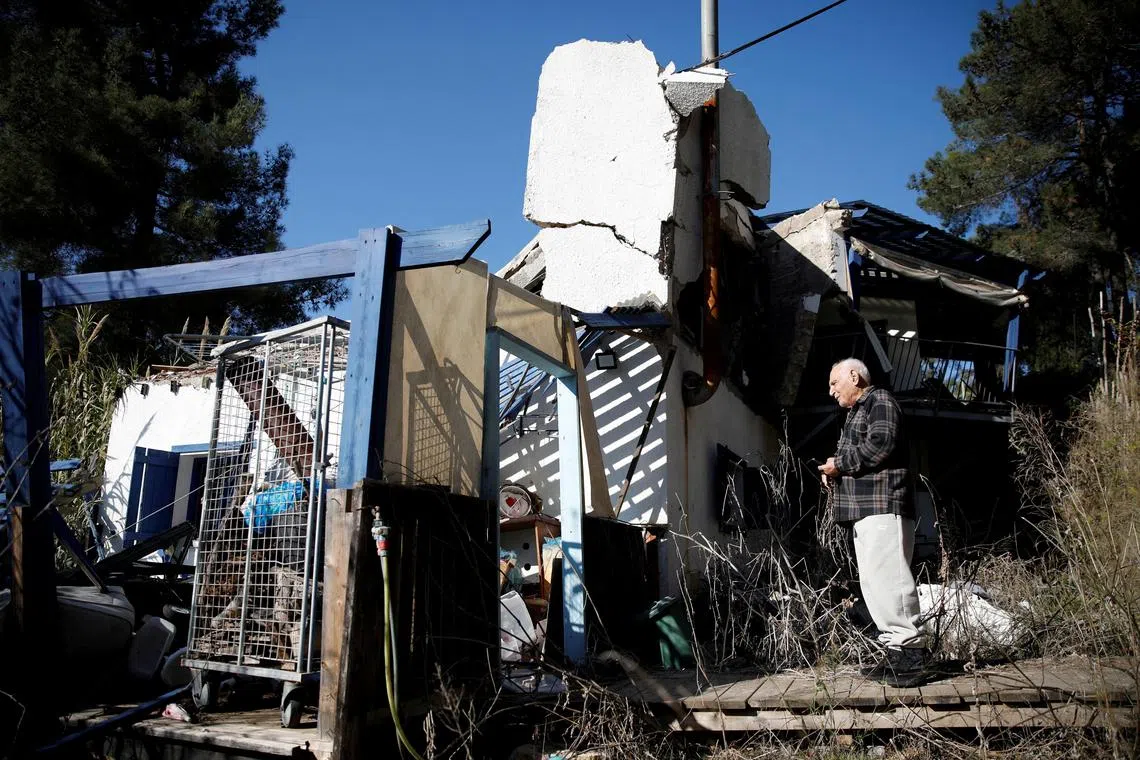Eli Moalem, resident of Manara, looks at a damaged building near the Israel-Lebanon border, following the ceasefire between Israel and Iran-backed group Hezbollah, in Manara, northern Israel, December 2, 2024. REUTERS/Shir Torem