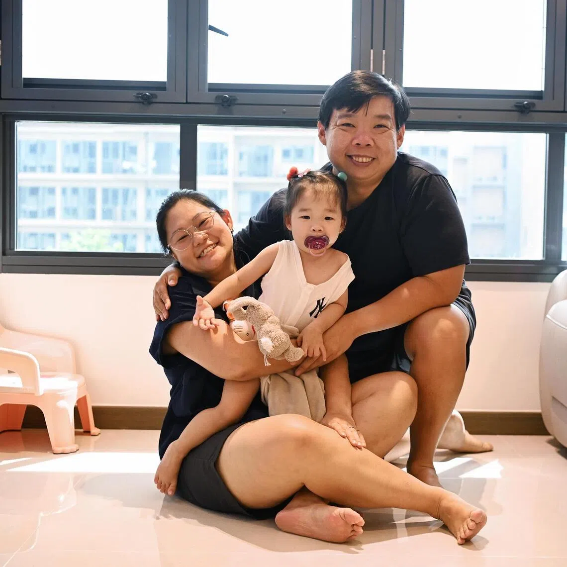 Housewife Felicia Lee (left) was diagnosed with Familial Adenomatous Polyposis when she was 12. Seen here with her husband Mr Cedric Ng and their one-year-old daughter Phoebe who was conceived through IVF.