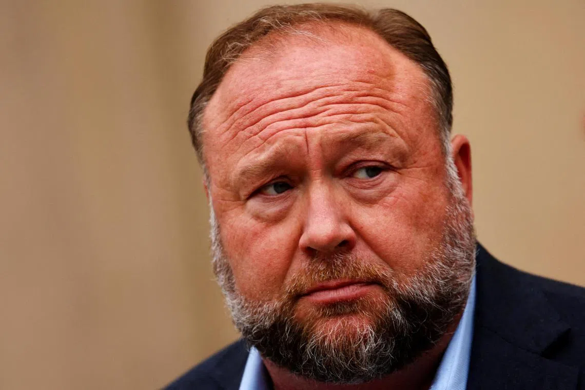 FILE PHOTO: Infowars founder Alex Jones speaks to the media after appearing at his Sandy Hook defamation trial at Connecticut Superior Court in Waterbury, Connecticut, U.S., October 4, 2022. REUTERS/Mike Segar/File Photo