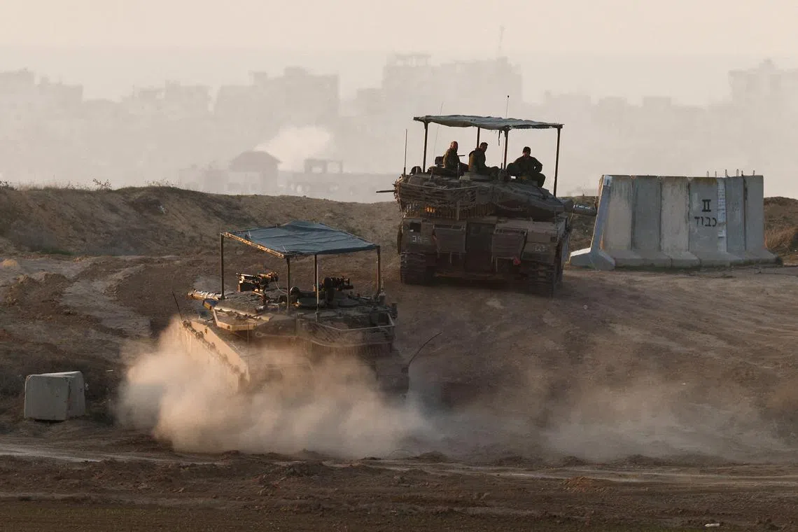Israeli tanks take a position, amid the ongoing conflict in Gaza between Israel and Hamas, near the Israel-Gaza border, as seen from Israel, December 22, 2024. REUTERS/Amir Cohen