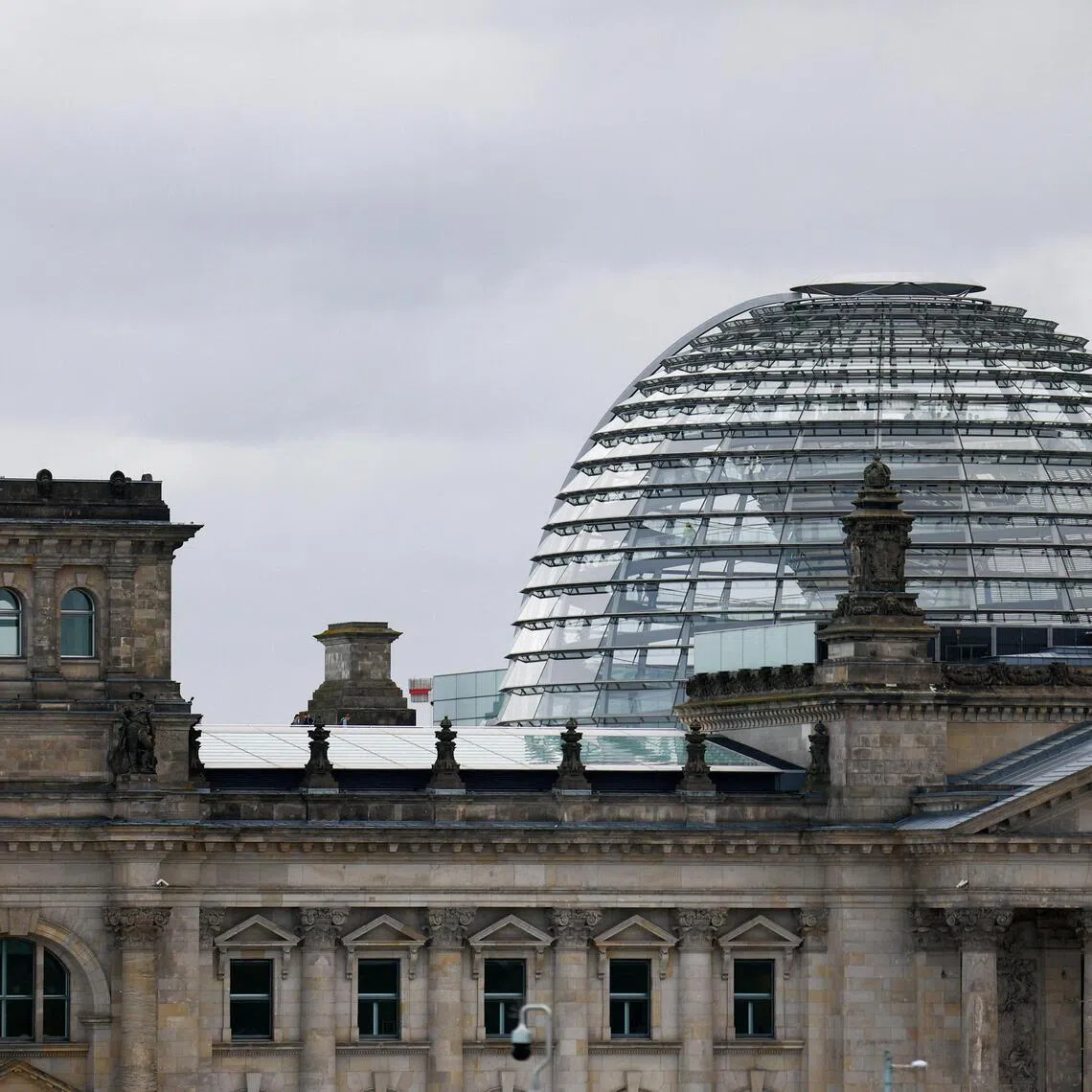 FILE PHOTO: The German flag flutters outside the Reichstag building, the seat of the German parliament, the Bundestag, in Berlin, Germany, September 16, 2025. REUTERS/Lisi Niesner/File Photo