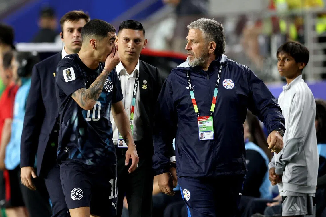 Miguel Almiron (left) of Paraguay reacting after receiving a red card for covering his mouth while talking to another player during the game against Turkey on June 19.