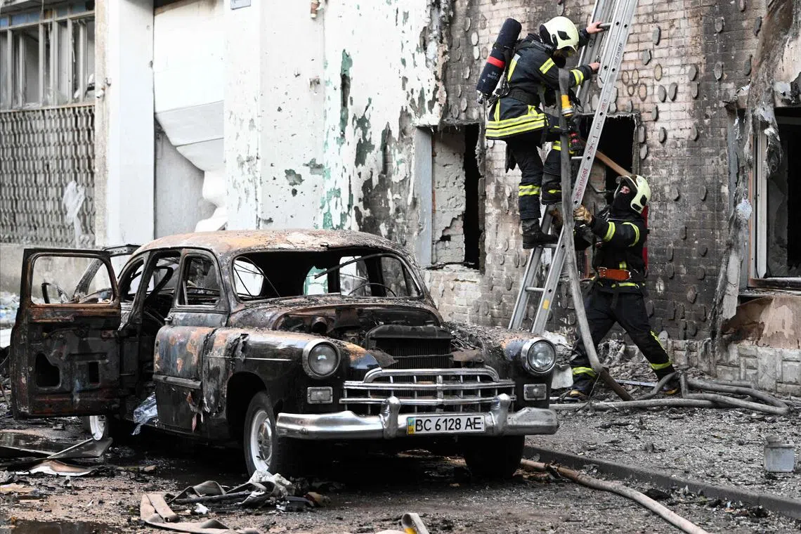 Firefighters working in the western Ukrainian city of Lviv on July 12, following Russian drone and missile strikes across Ukraine.