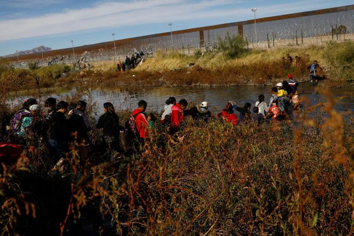 Migrants seeking asylum in the United States cross the Rio Bravo River, the border between the U.S. and Mexico, as seen from Ciudad Juarez, Mexico, December 5, 2023. REUTERS/Jose Luis Gonzalez/File Photo