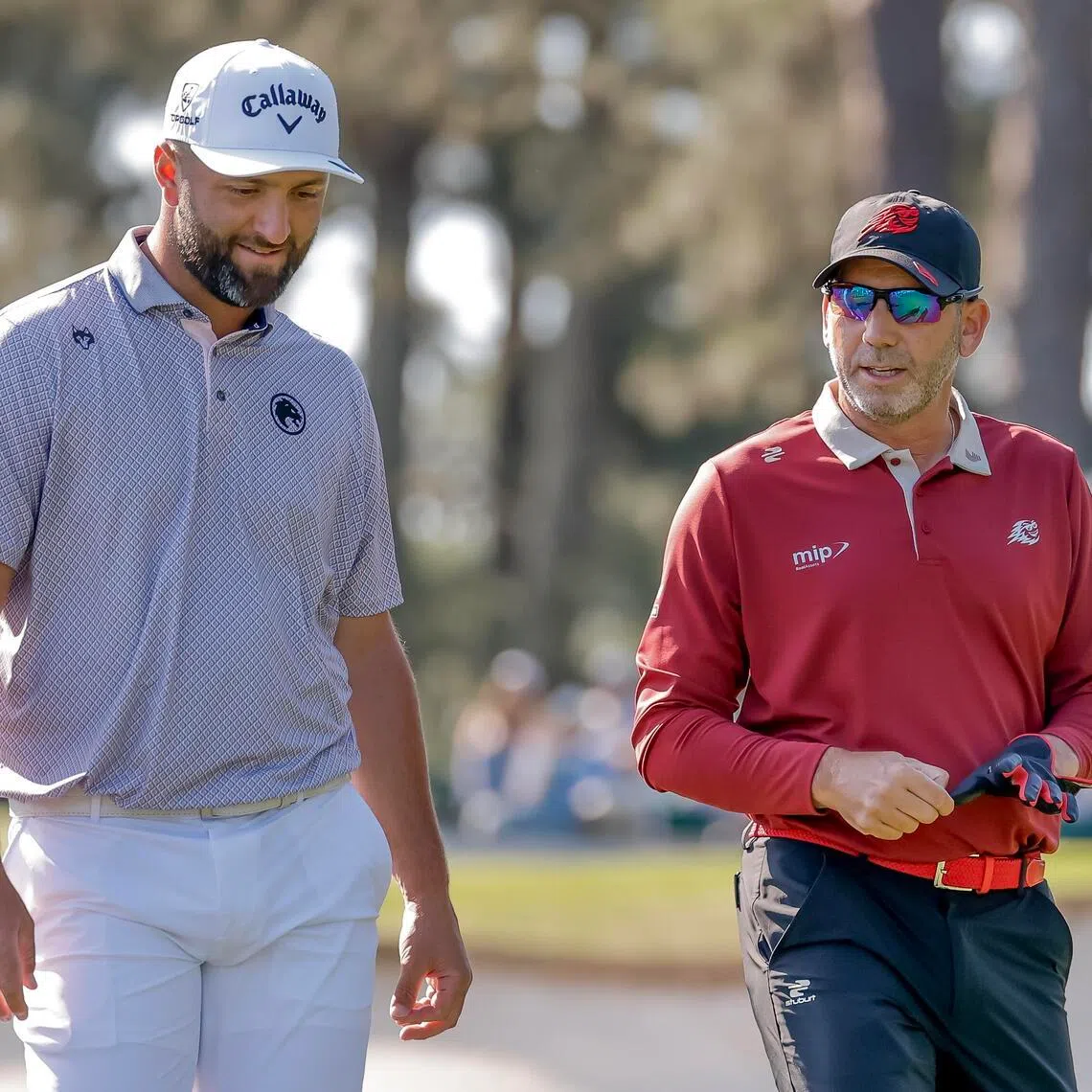 Jon Rahm (left) and Sergio Garcia walk off the tee on the third hole during the final round of the 2026 Masters Tournament at the Augusta National Golf Club.