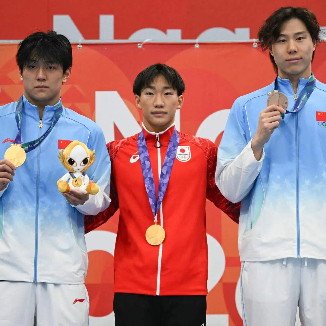 Japan’s Shin Ohashi (centre) shared the men’s 100m breaststroke gold with China’s Dong Zhihao (left), while Qin Haiyang settled for bronze.