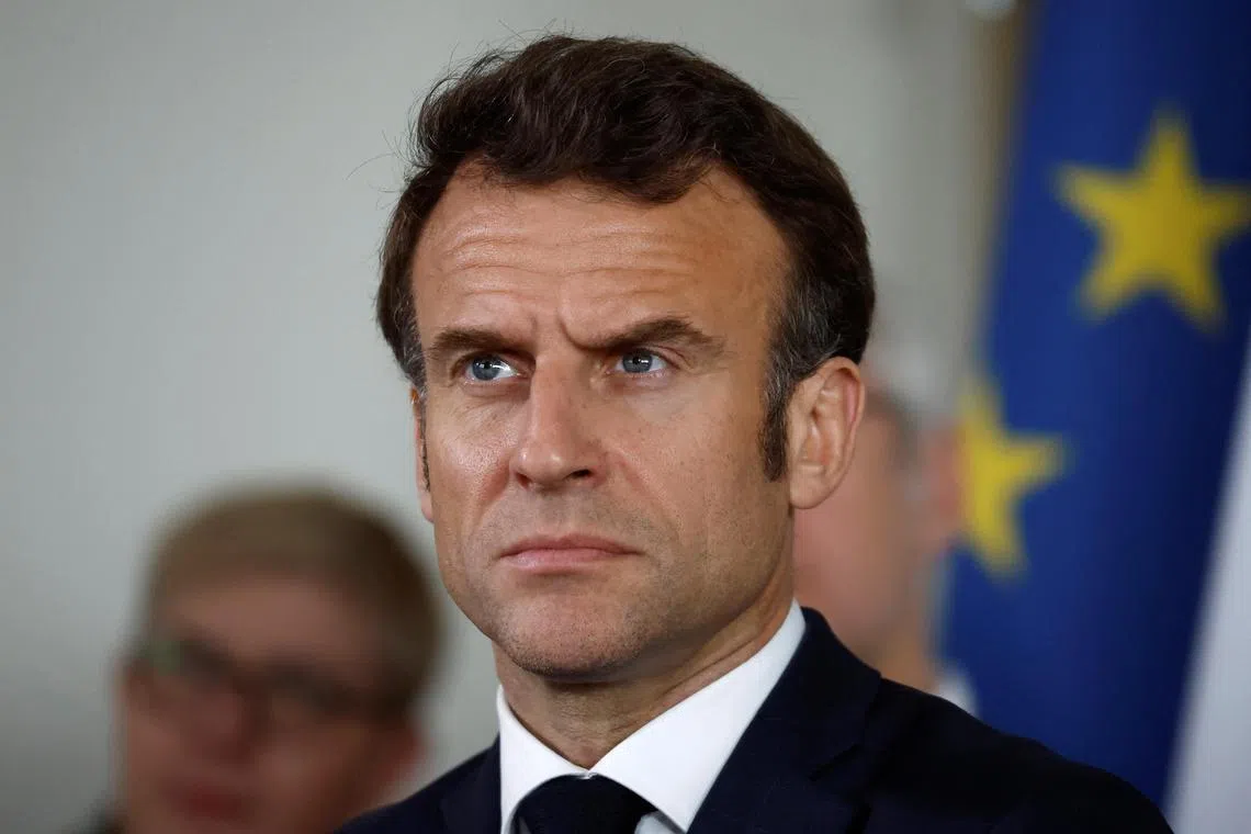 French President Emmanuel Macron meets health professionals at a health centre in Vendome.