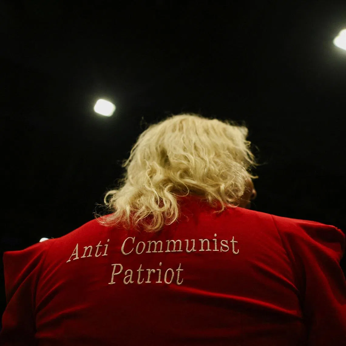 An attendee wears an outfit with \"Anti Communist Patriot\" written on it in Palm Beach County Convention Center, in West Palm Beach, Florida, U.S., November 5, 2024. REUTERS/Callaghan O'hare