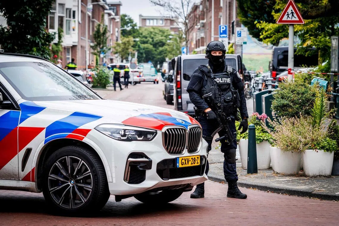 A Dutch police officer standing guard after a clandestine drug laboratory was discovered in a house on Meidoornstraat, in The Hague, on July 18.