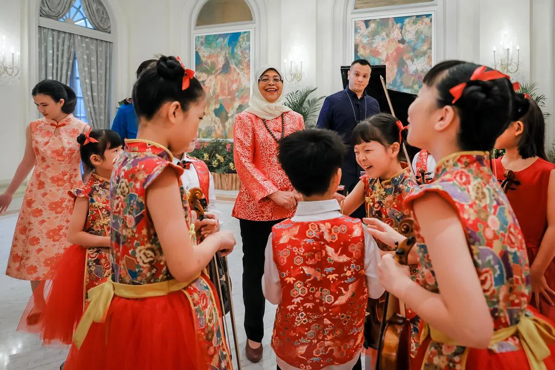 President Halimah Yacob engaging with NAFA School of Young Talents performers at the Istana Open House on Jan 23, 2023.
