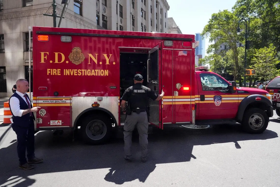A New York City Fire Department (FDNY) truck stands parked outside 26 Federal Plaza, which houses the FBI's New York City field office and the Immigration and Customs Enforcement (ICE) field office, following reports that a person deployed an incendiary device, in New York City, U.S., July 20, 2026. REUTERS/David Dee Delgado