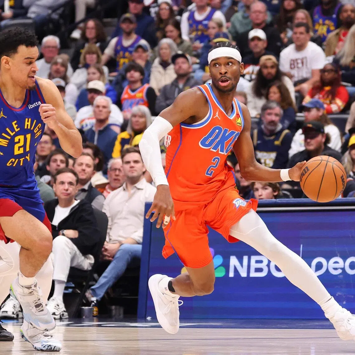 Shai Gilgeous-Alexander of the Oklahoma City Thunder drives to the basket against Spencer Jones of the Denver Nuggets during the fourth quarter at Ball Arena.