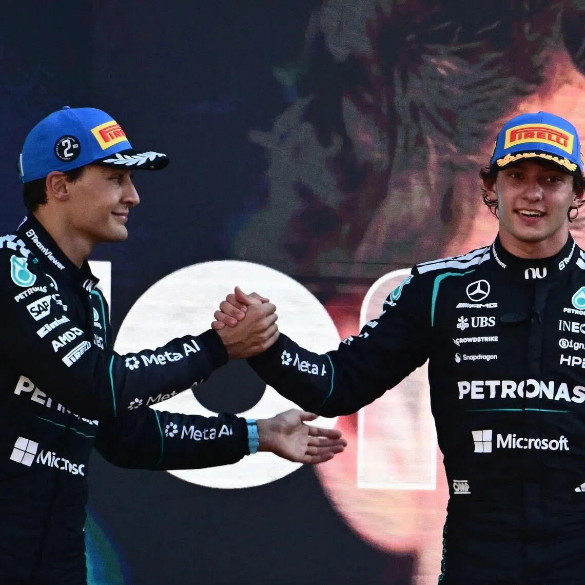 British driver George Russell (left) congratulates his Mercedes teammate Kimi Antonelli after the Italian won his home Formula 1 Grand Prix in Monza on Sept 6.
