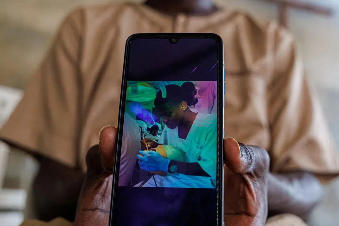 A brother of Abdoulaye Ba, a student who, according to other students, was killed at the Cheikh Anta Diop University (UCAD) campus during protests over financial aid that turned violent, shows Abdoulaye's photo on his mobile phone at their house in Dakar, Senegal, February 12, 2026. REUTERS/Zohra Bensemra
