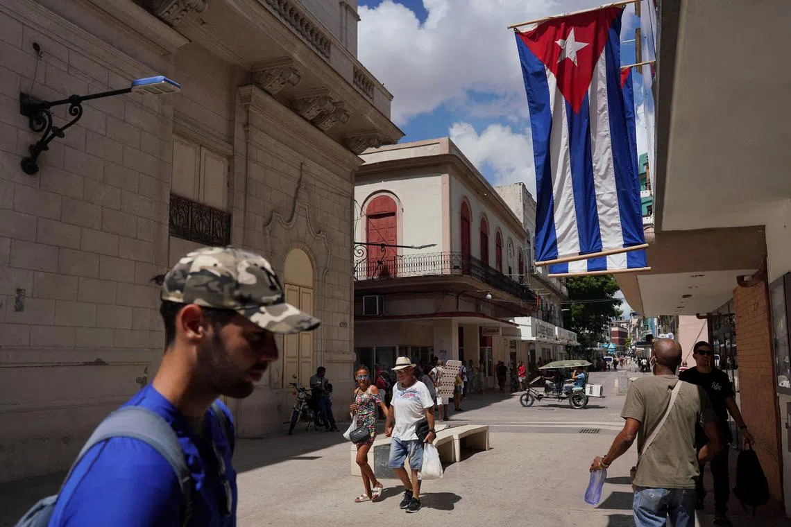 FILE PHOTO: Cuban flags are displayed at a commercial road in downtown Havana, Cuba, July 20, 2022. REUTERS/Alexandre Meneghini/File Photo