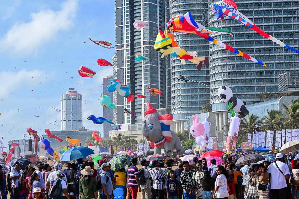 People take part in the Colombo International Kite Festival in Colombo on August 24, 2025. (Photo by Ishara S. KODIKARA / AFP)