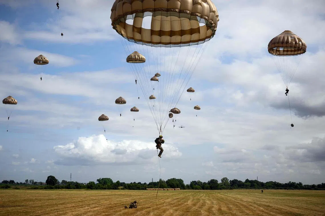 Soldiers of the 3rd Marine Infantry Parachute Regiment landing in a field as they take part in the military exercise 'Cathare 25', involving over 800 active and reserve military personnel, near Pamiers, on June 26, 2025. 