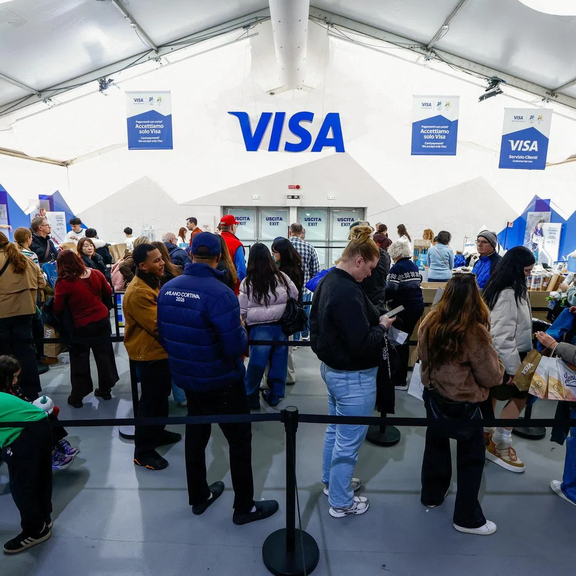 FILE PHOTO: People line up to check out at the Olympics megastore in Milan, Italy, February 11, 2026. REUTERS/Alessandro Garofalo/File Photo
