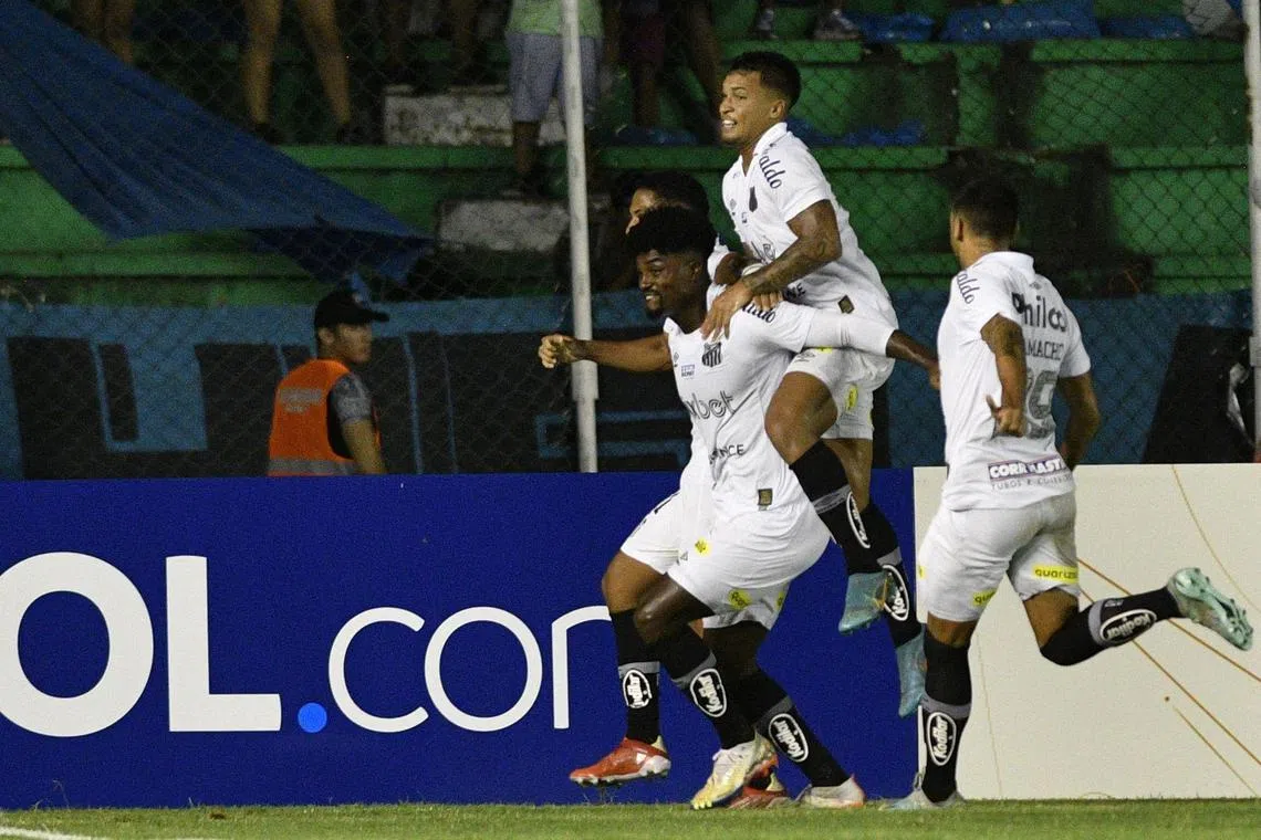 Santos defender Eduardo Bauermann (centre) is accused of receiving at least 50,000 reais to get a yellow card in a match in 2022.