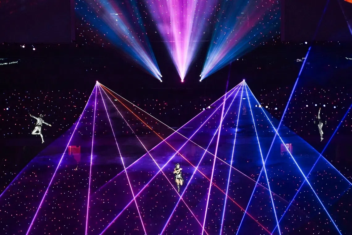 Singer Jasmine Sokko (centre) performing with two aerialists at the National Stadium on Aug 9.