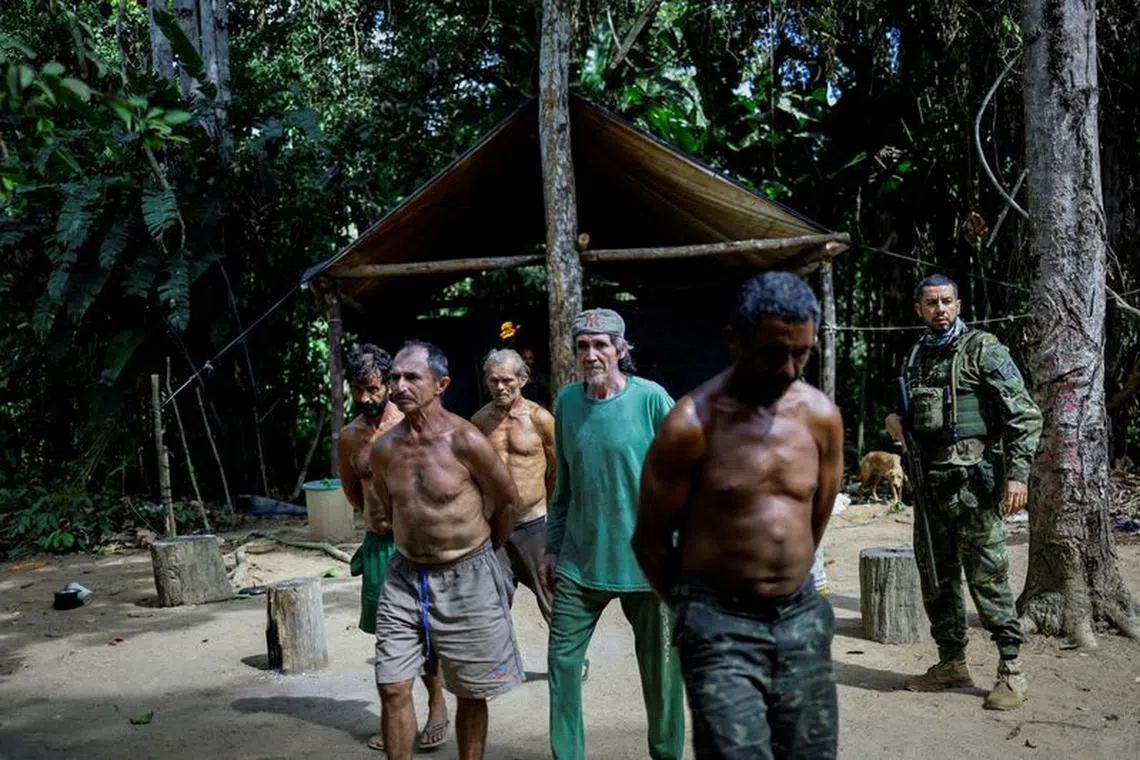Illegal miners are detained by a members of the Special Inspection Group from the Brazilian Institute of Environment and Renewable Natural Resources (IBAMA) during an operation against illegal mining in Yanomami Indigenous land, Roraima state, Brazil, December 5, 2023. A year after President Luiz Inacio Lula da Silva declared a humanitarian crisis among the Yanomami and vowed zero tolerance for illegal mining, environmental enforcers warn that Brazil is jeopardizing last year's hard-won progress, when about 80 percent of roughly 20,000 wildcatters were ousted from the Portugal-sized reservation. As the Brazilian military has rolled back its support for the government crackdown, the gold-seeking miners have come back, they say, making fresh incursions into Yanomami land.        REUTERS/Ueslei Marcelino