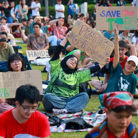 Attendees holding signs and placards at the Maju for the People Rally at Hong Lim Park on Aug 16. Wishing away land-use trade-offs is no substitute for rigorous debate, the writer says.